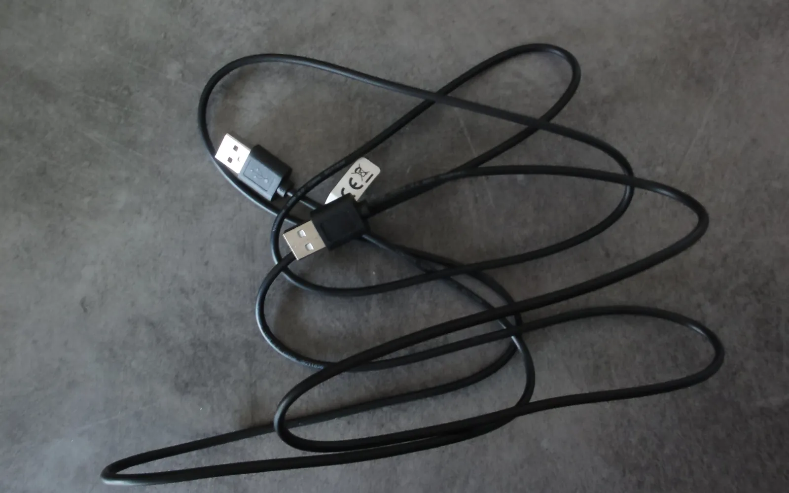 A USB cable with its connectors on a plain background